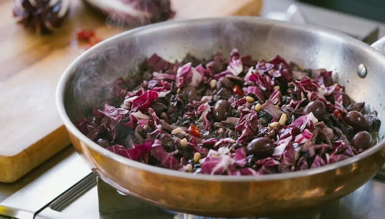 Radicchio in padella con olive e pinoli, un contorno saporito che profuma di casa.