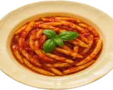 Pasta with tomato sauce and basil in a yellow bowl.