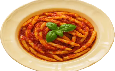 Pasta with tomato sauce and basil in a yellow bowl.