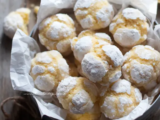 Biscotti al limone spolverati di zucchero a velo, morbidi e profumati, pronti per essere gustati.